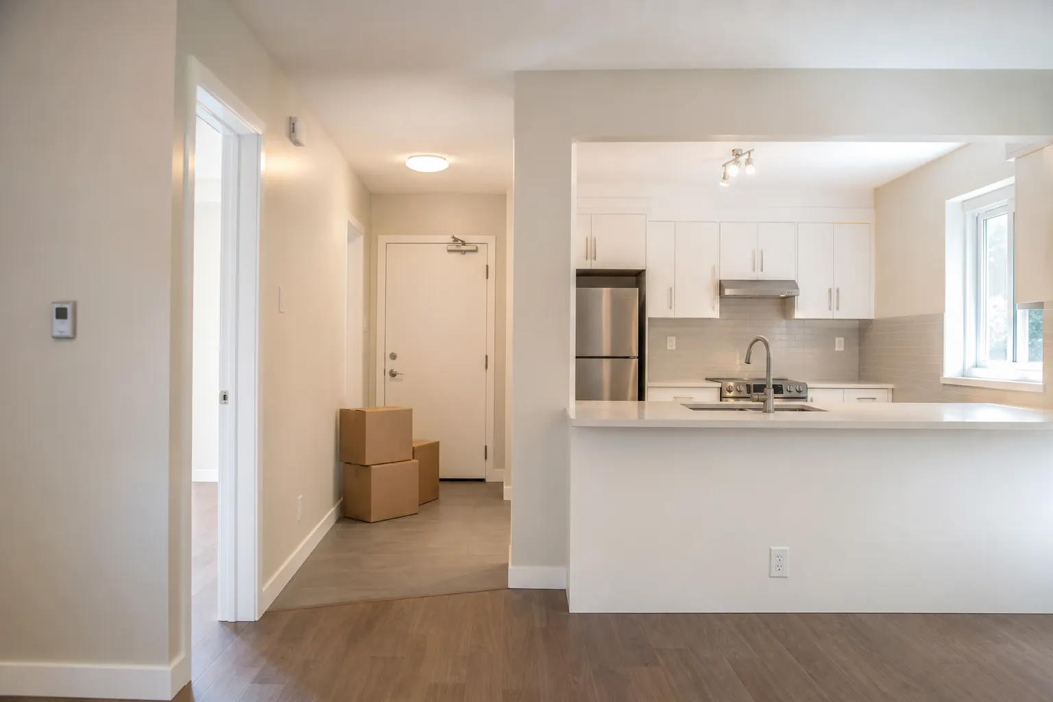 Clean empty rental flat with moving boxes