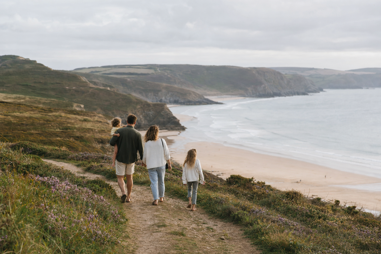 Family walking together on a quiet South West beach path
